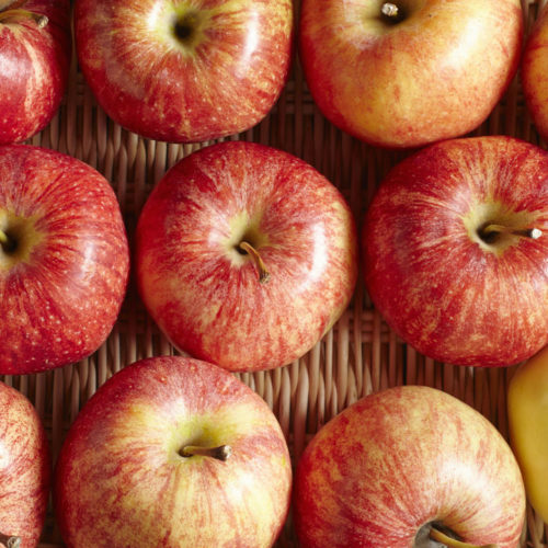 Organic gala apples in a wicker basket